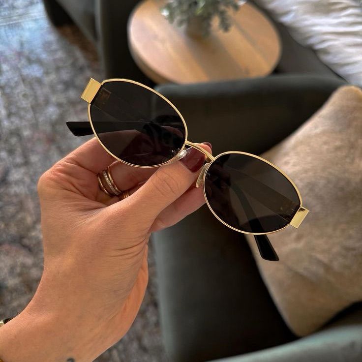 stylish gold and black oval sunglasses perfect for…